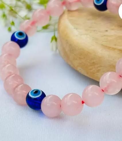 Close-up of rose quartz crystal bracelet showing natural texture and clarity
