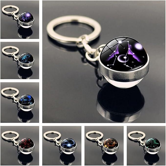 A circular keychain bracelet made of smooth, polished natural gemstone beads, featuring a central metallic charm engraved with a zodiac sign symbol and a sturdy silver key ring attachment.