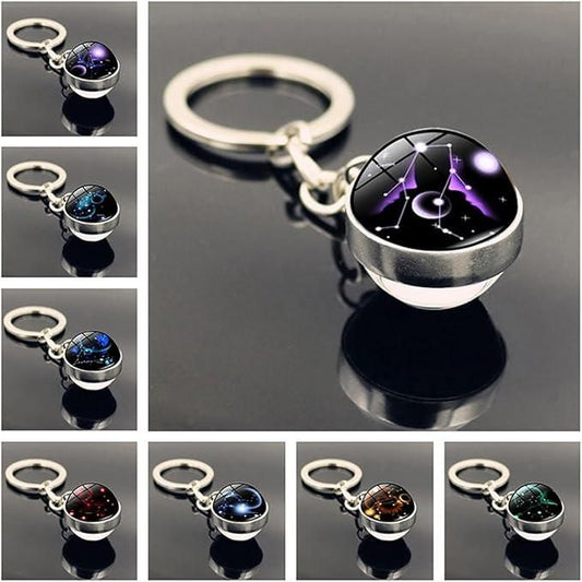 A circular keychain bracelet made of smooth, polished natural gemstone beads, featuring a central metallic charm engraved with a zodiac sign symbol and a sturdy silver key ring attachment.